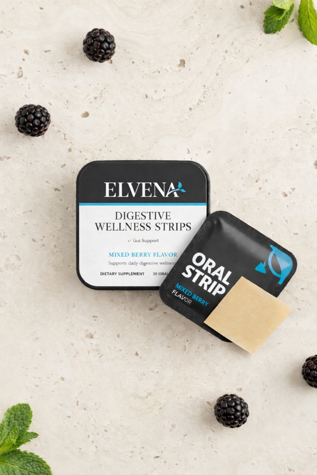 ELVENA Digestive Wellness Strips tin with oral strip sachet and beige dissolvable strip on a stone surface with blackberries.